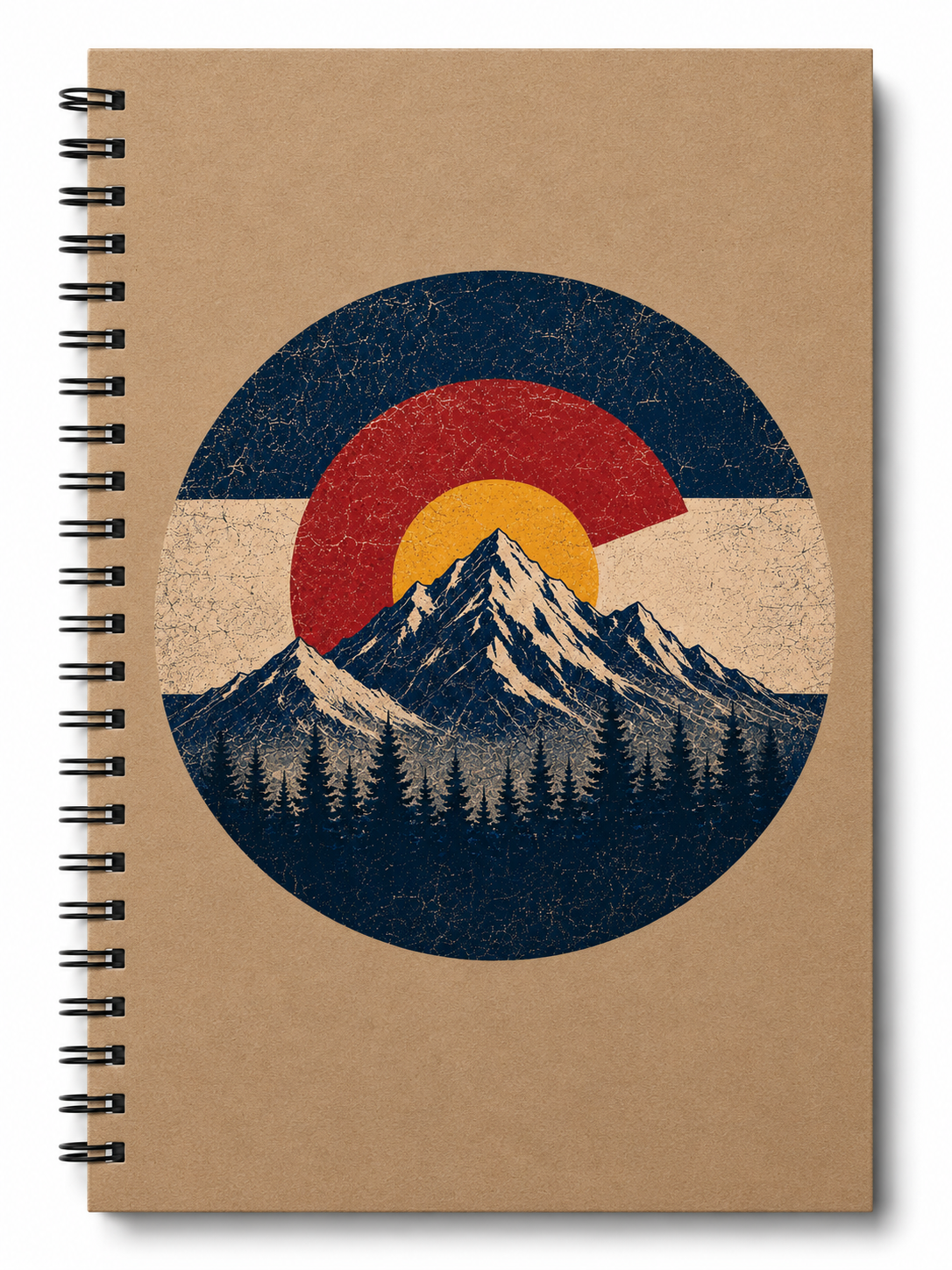 A spiral-bound notebook with a kraft brown cover featuring a circular graphic of a mountain peak in front of a red, yellow, and blue sun over a white band, resembling the Colorado state flag.