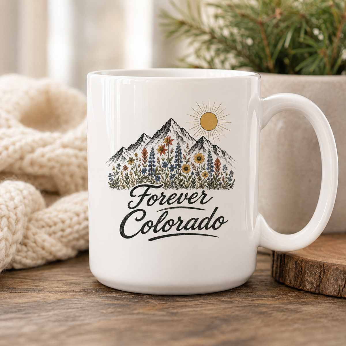 White 15 ounce ceramic Forever Colorado mug with mountain and wildflower illustration