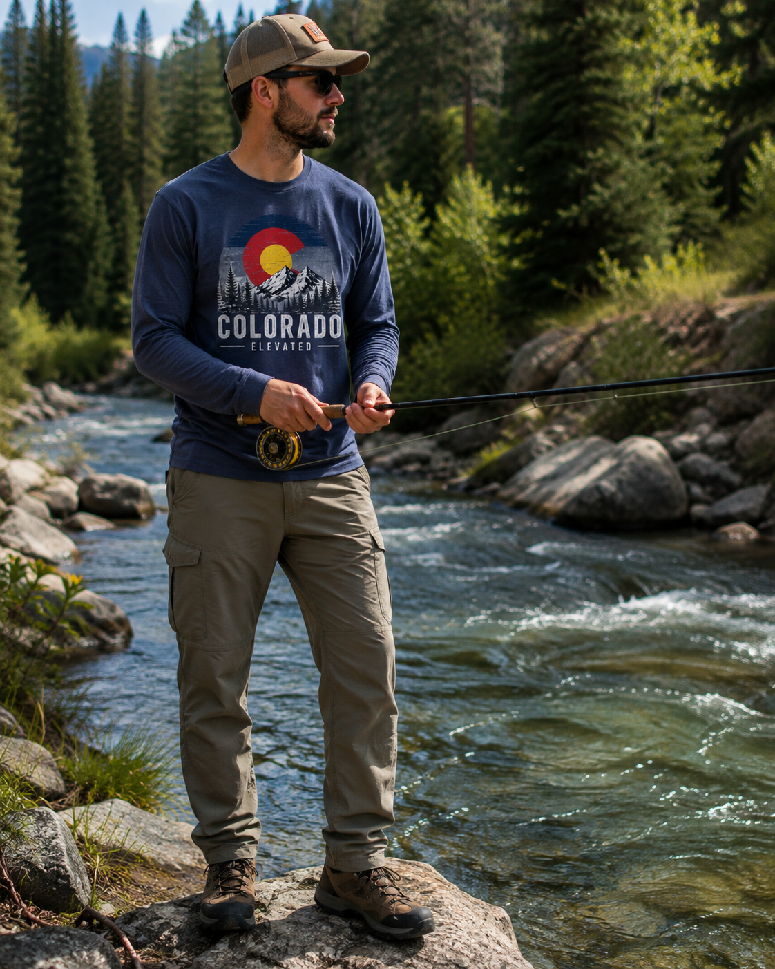 Man fly fishing in Colorado wearing the Colorado Elevated Navy Long-Sleeve Tee