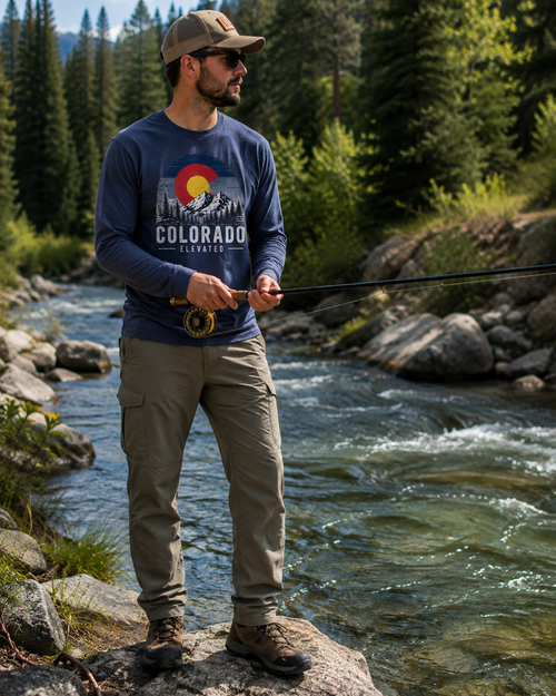 Man fly fishing in Colorado wearing the Colorado Elevated Navy Long-Sleeve Tee
