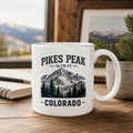 White 15 ounce ceramic Pikes Peak Colorado mug with mountain illustration
