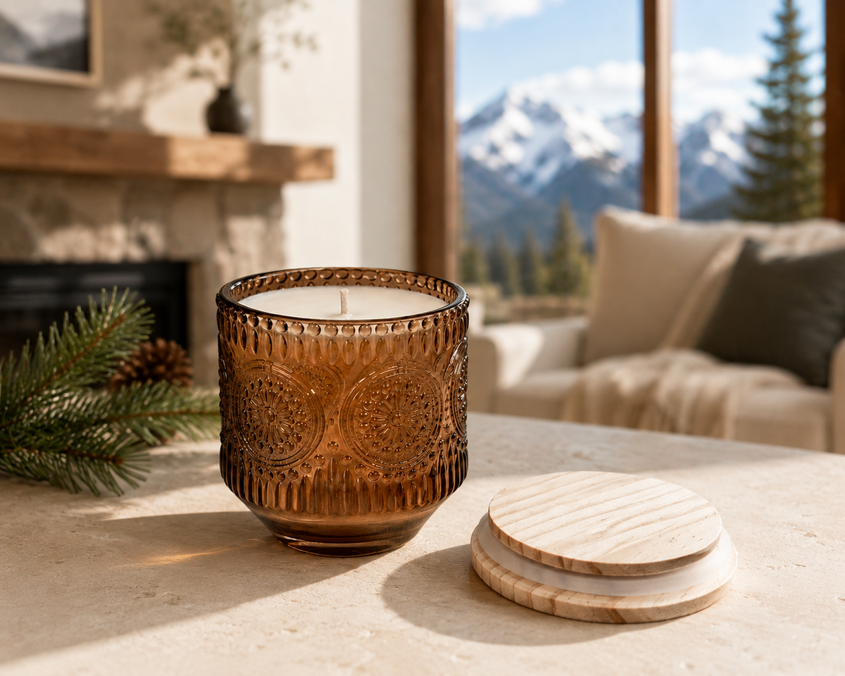 Rustic amber glass Colorado Mountain Candle with pine branches and mountain backdrop